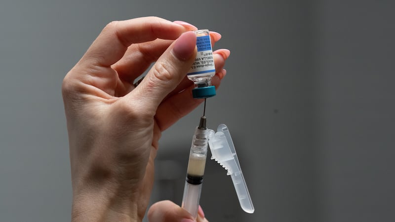 FILE - Lauren Ellenburg, a nurse, prepares a combination measles, mumps and rubella vaccine...