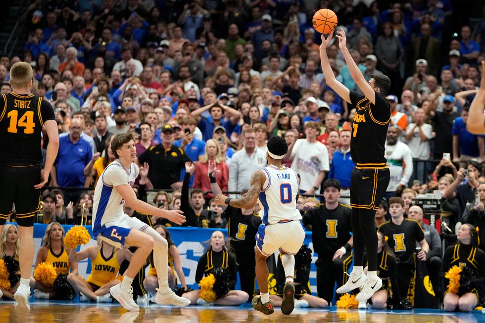 Iowa forward Alvaro Folgueiras (7) puts up a three point shot against Florida during the...
