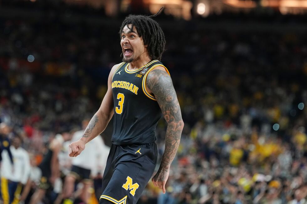 Michigan's Elliot Cadeau reacts during the first half of an NCAA college basketball tournament...