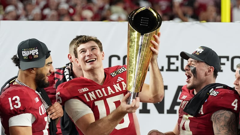 Indiana quarterback Fernando Mendoza holds the trophy after their win against Miami in the...
