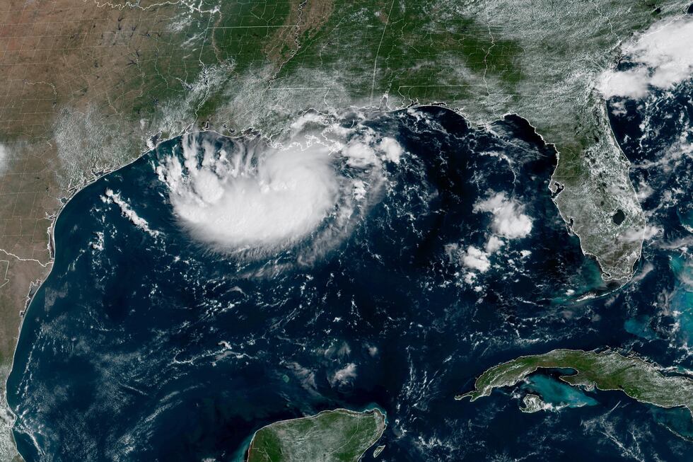 This satellite image released by NOAA shows Potential Tropical Cyclone Five forming over the...