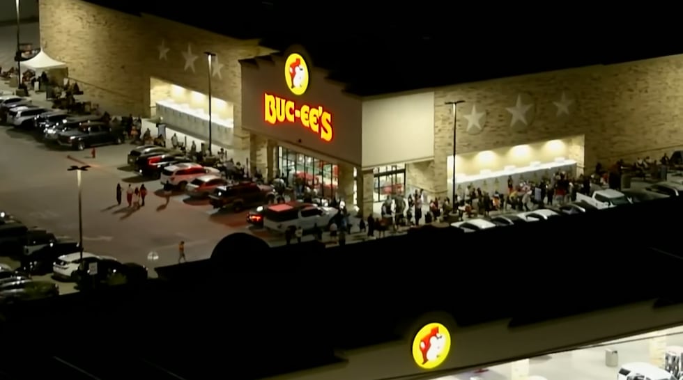 A long line of fans lined up outside the new Texas-sized gas station near Interstate 10 and...