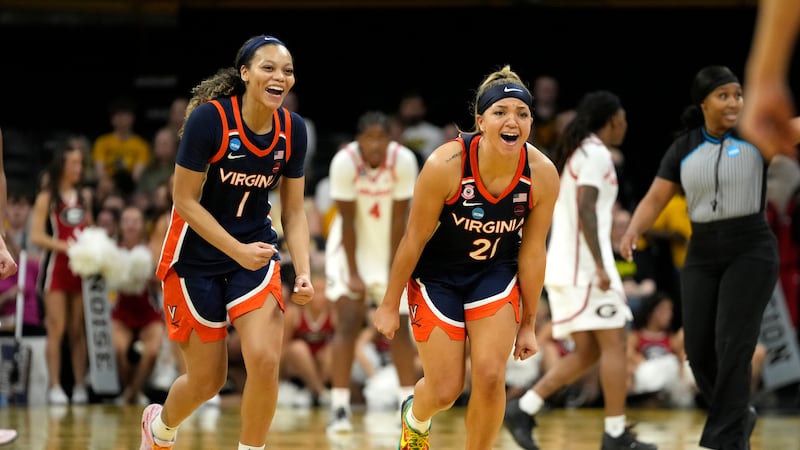 Virginia guards Paris Clark (1) and Kymora Johnson (21) celebrate at the end of a first round...
