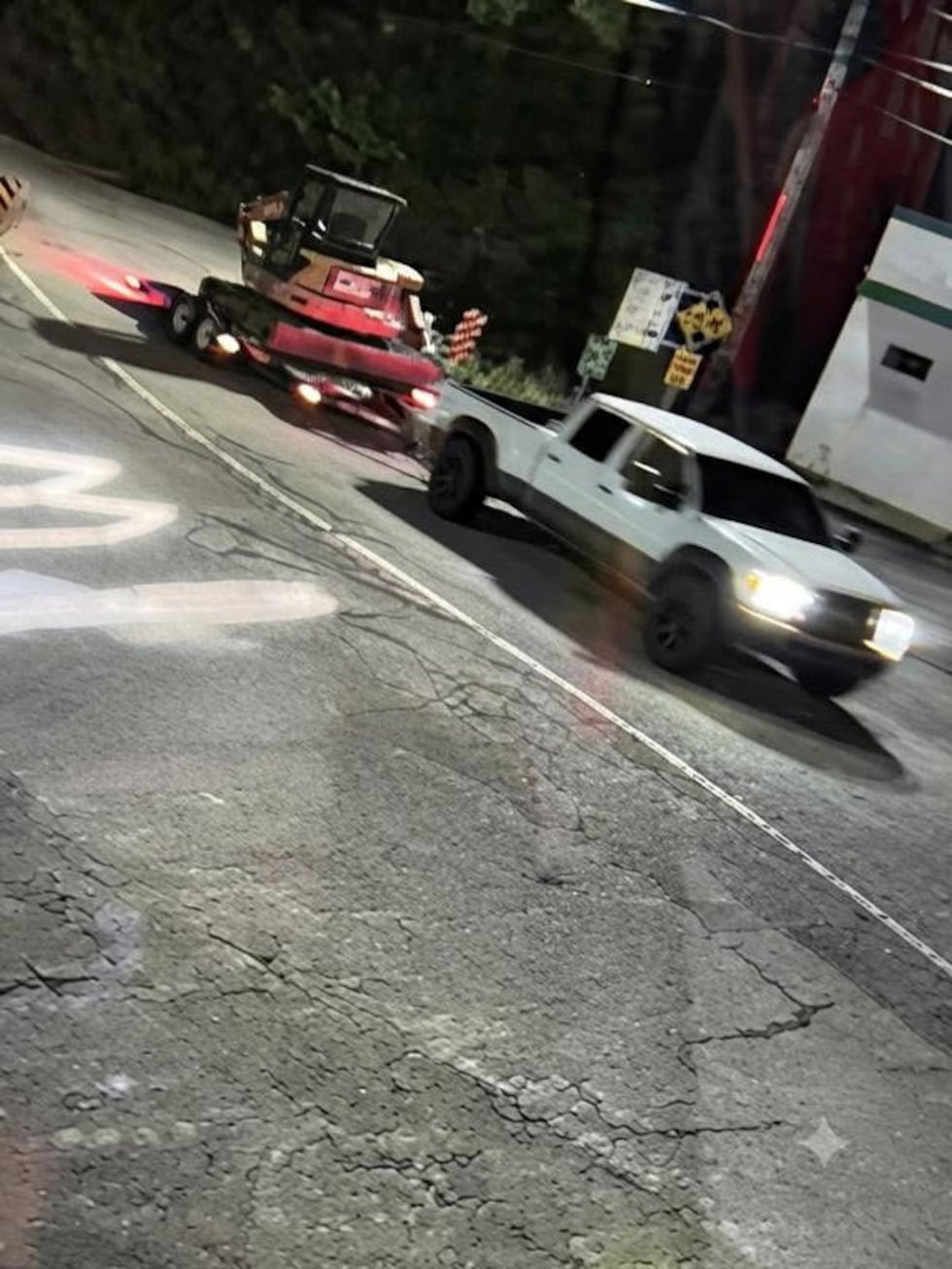 Police say the excavator was loaded onto a long flatbed bumper pull trailer attached to an...
