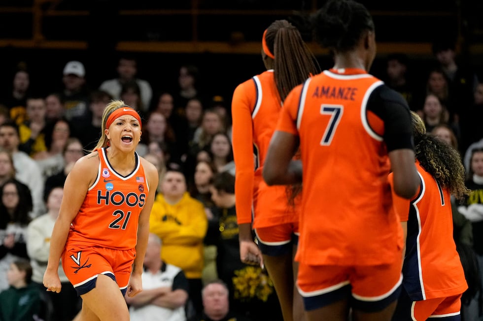 Virginia guard Kymora Johnson (21) celebrates after making a three-point basket during the...