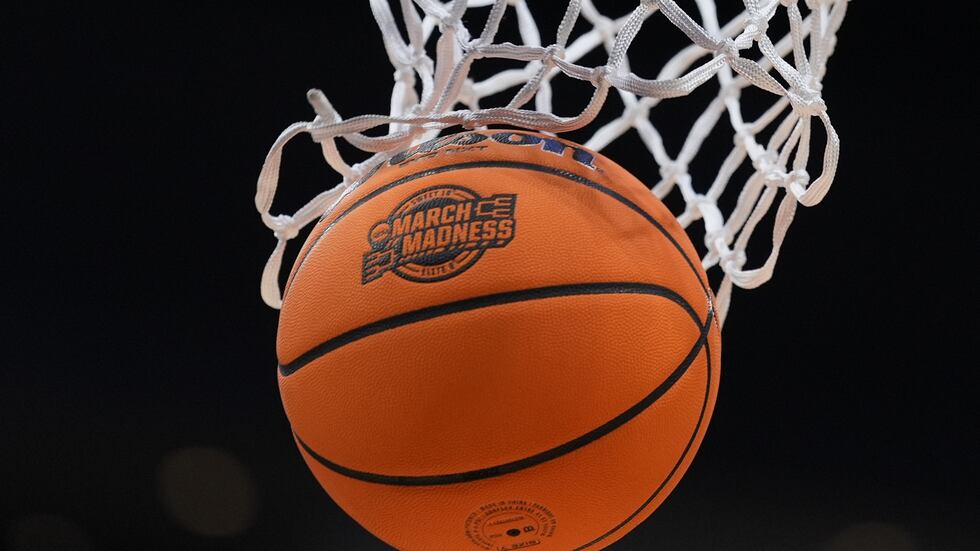 FILE - A basketball goes throw the net before an Elite Eight game between Iowa and Illinois in...